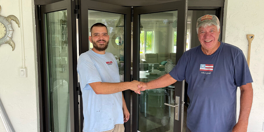 Homeowner shaking hands with install tech